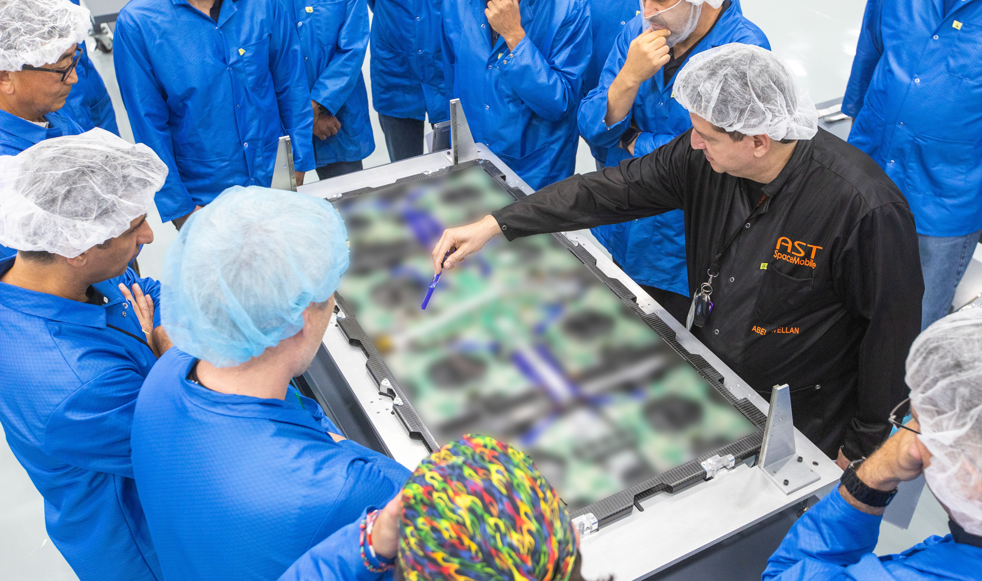 Abel Avellan, the founder, Chairman, and CEO of AST SpaceMobile, shows employees in the company's Midland, Texas headquarters the internal components of a Micron panel in August 2023. Such panels were used to build Block 1 BlueBird commercial satellites, which were designed to provide the first-ever space-based cellular broadband service to unmodified mobile phones. Five of the satellites launched on September 12, 2024 and unfolded throughout October 2024.